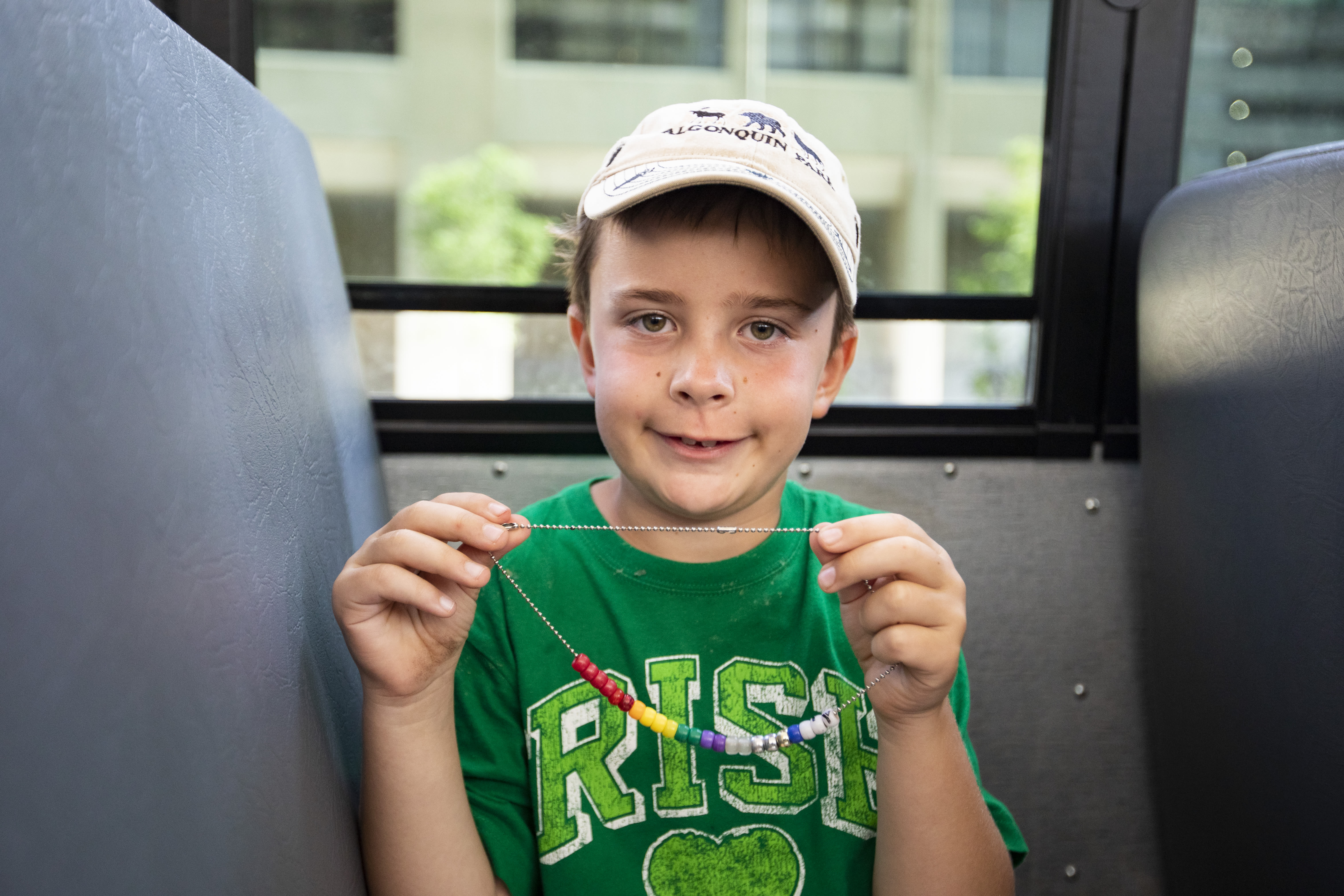 A camper is in a bus and is showing off their Value Beads.