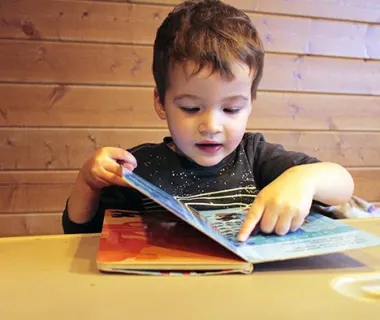 Preschool boy learning to read
