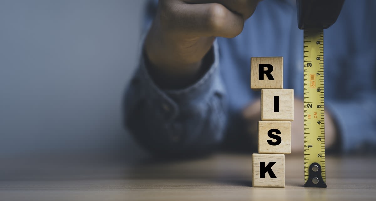 four wooden dice forming the word risk