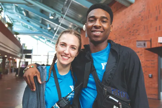 Two YMCA Volunteers with walki-talkies at a centre enjoying work