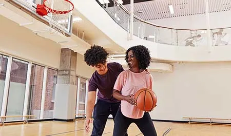 Boy and girl playing basketbal
