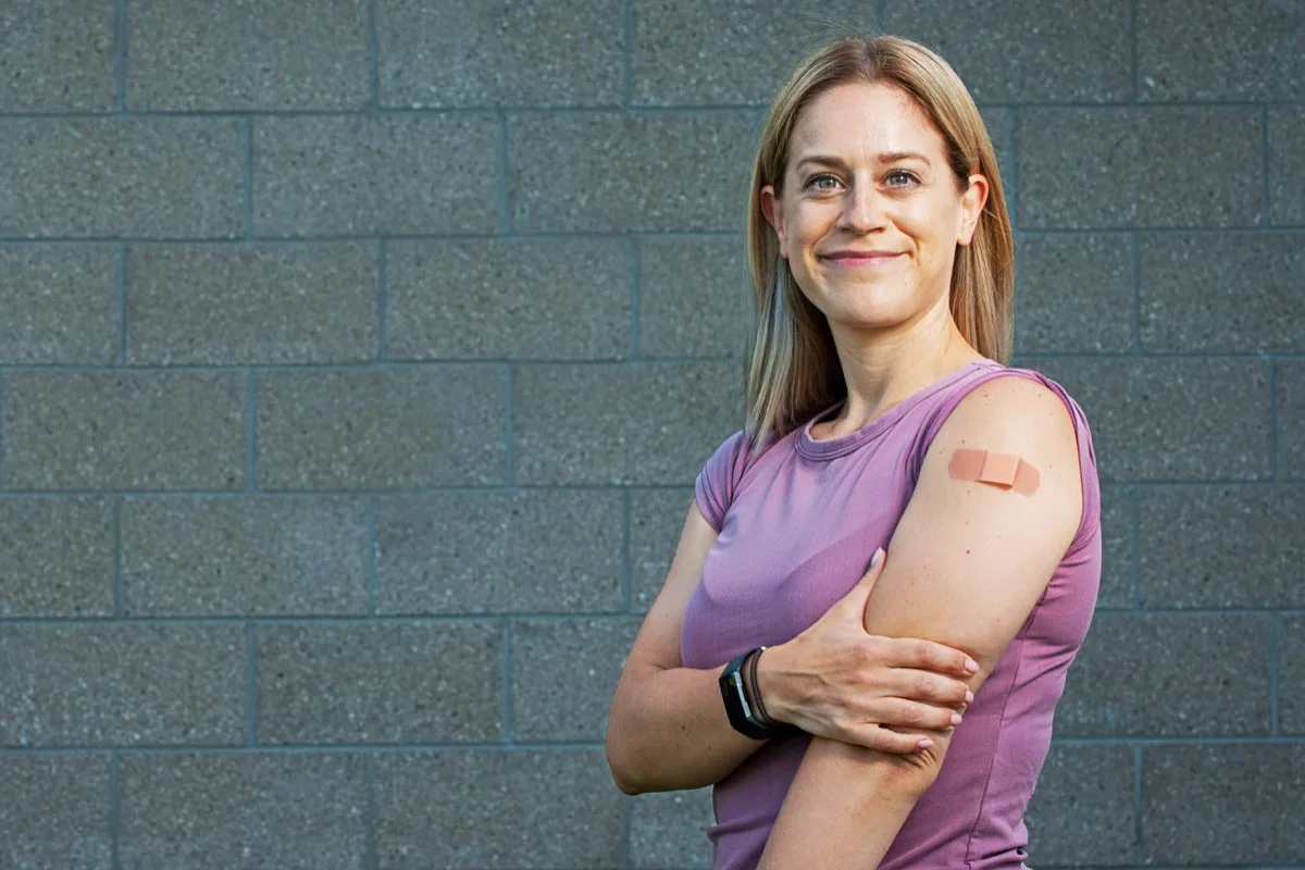 Woman with vaccination bandage on her arm