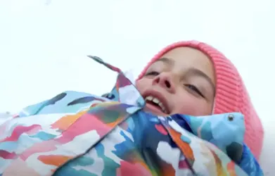 a girl making a snow angel