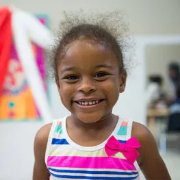 a young girl smiling