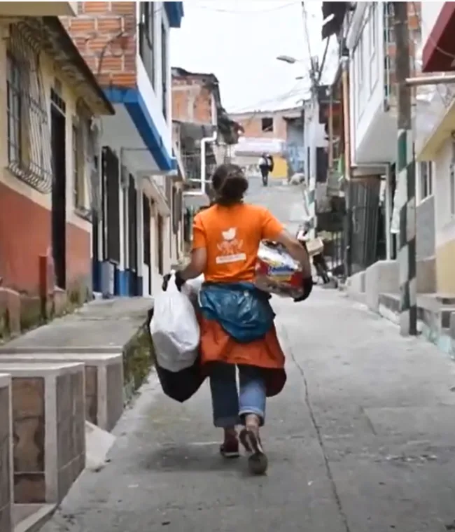 person walking down a street, holding bags in Risaralda Colombia