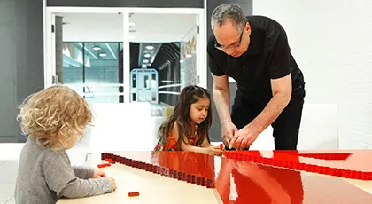 Medhat Mahdy helps children build a Y with building blocks