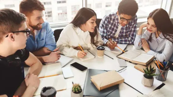 a group of people working at the table