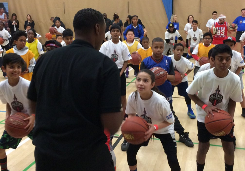 NBA Legend Isiah Thomas helping kids with basketball drills