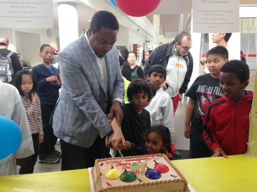 Community members cut the cake at Markham YMCA