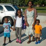 Mother walking 3 children to school