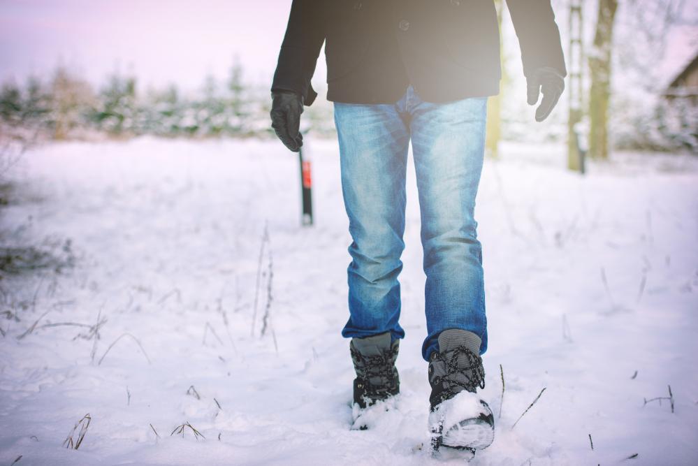 Man walking in snow with winter clothes on